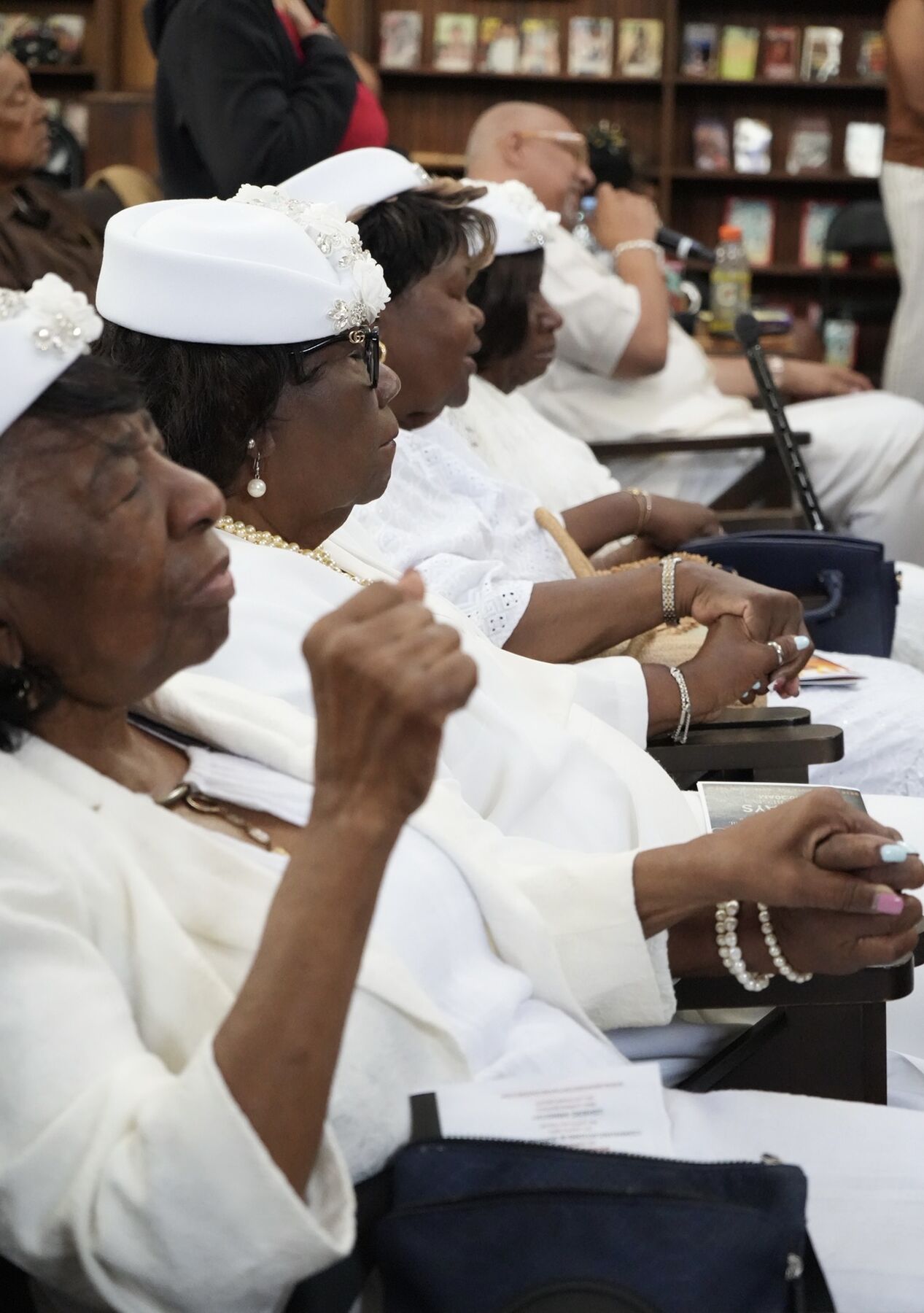 Church mothers dressed in white during worship