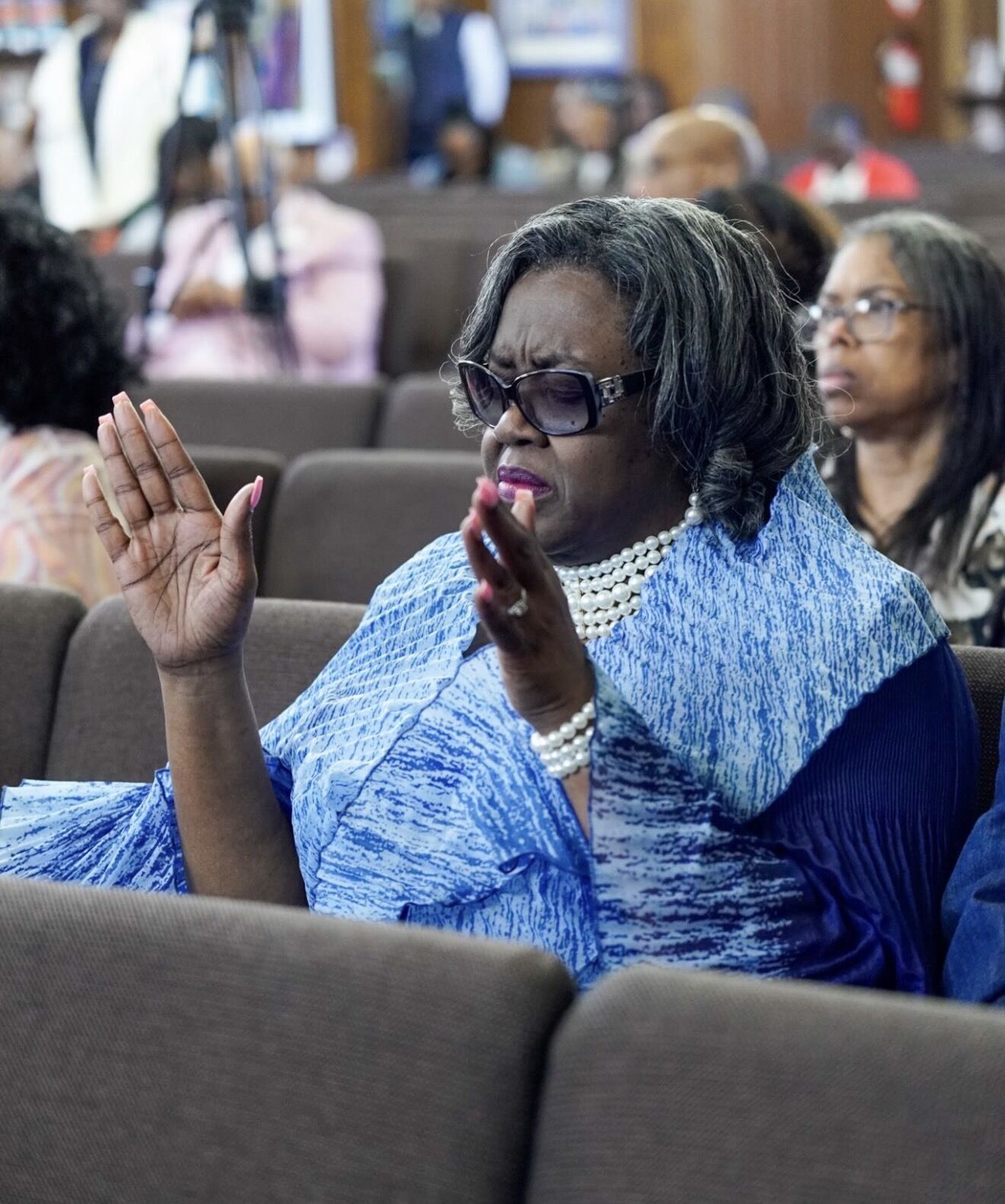 A member praising with hands raised